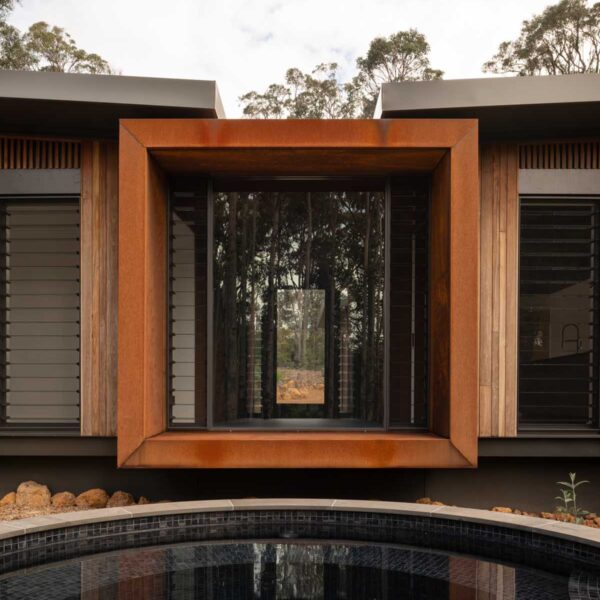 Square framed front entrance and edge of pool from Treehouse by Suzanne Hunt Architect